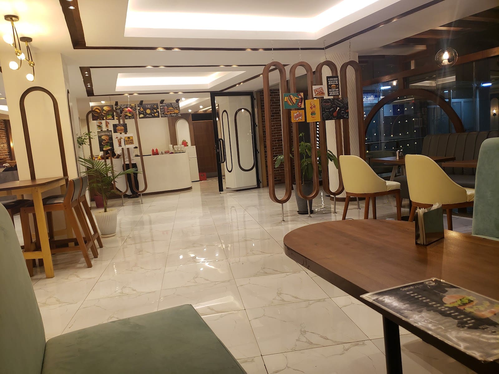 Inside the Dada Mall branch: marble floor, wooden arches and the Burger Zone counter